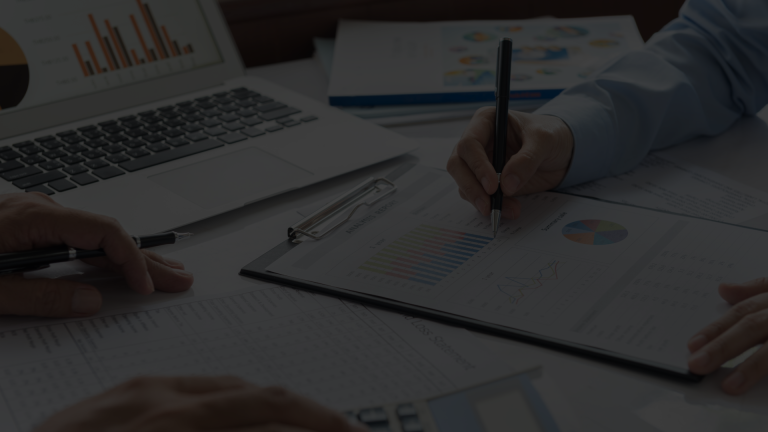 Business team analyzing financial data charts and performance reports during a meeting