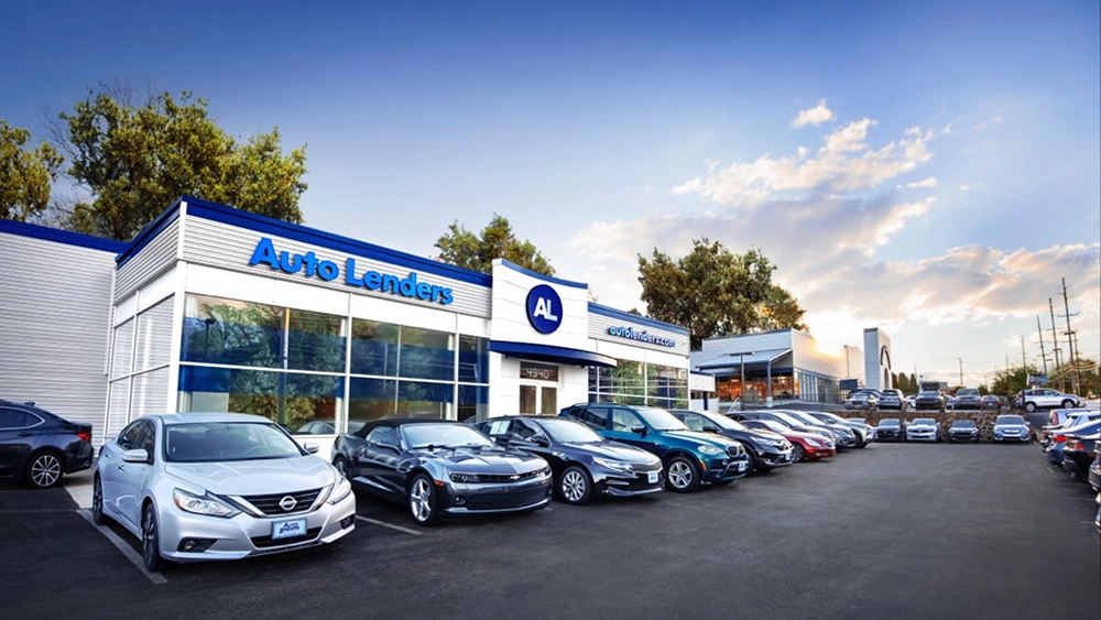 Auto Lenders car dealership showroom with vehicles displayed outside the building